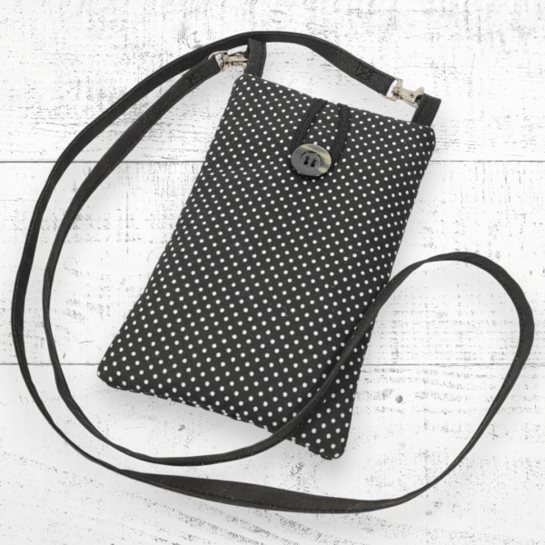 Offrez à votre téléphone une protection élégante et pratique avec cette pochette noire et blanche à bandoulière, pensée pour les femmes modernes.